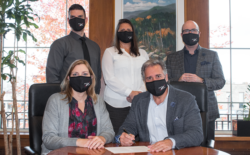 Oshawa Power executive team signing document